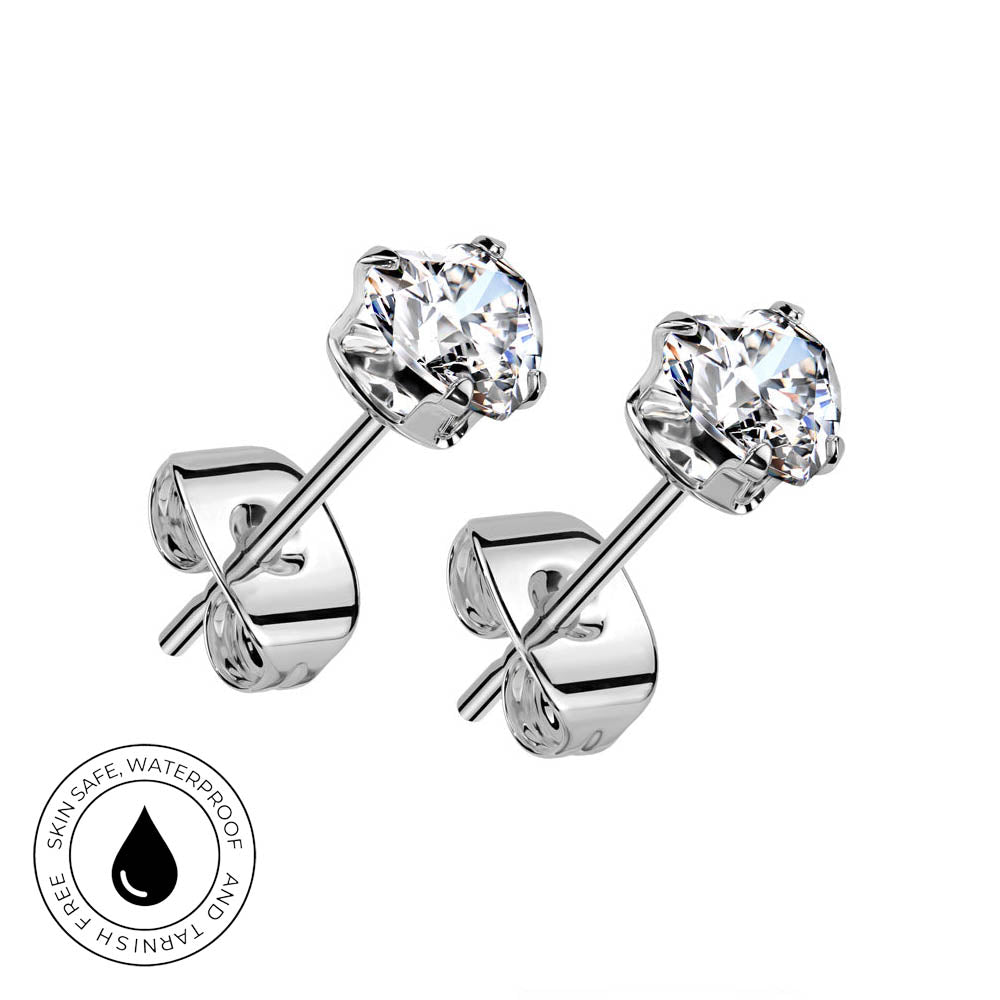 A pair of silver stud earrings with clear round-cut gemstones, shown on a plain white background. One earring is turned to show the back with a butterfly clutch, and the other is angled to show the front.