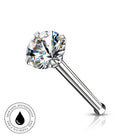 A single-prong solitaire nose ring featuring a clear, faceted gemstone on a polished silver-tone metal post. A circular graphic overlay in the bottom-left corner highlights 'SKINSAFE WATERPROOF' features.