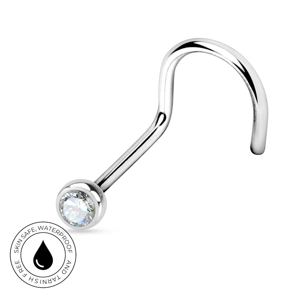 A curved silver-toned labret piercing stud with a clear faceted gemstone in a bezel setting, shown on a white background with a circular 'Skin Safe Waterproof' badge in the lower-left corner.