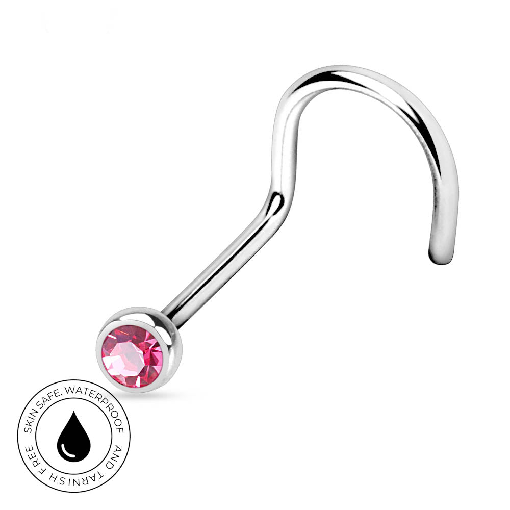 A curved silver-toned body jewelry barbell with a faceted pink gemstone in a bezel setting. A circular badge in the lower-left corner reads 'SKIN SAFE WATERPROOF AND TARNISH FREE' with a black droplet icon.