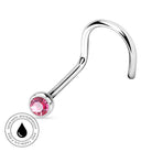 A curved silver-toned body jewelry barbell with a faceted pink gemstone in a bezel setting. A circular badge in the lower-left corner reads 'SKIN SAFE WATERPROOF AND TARNISH FREE' with a black droplet icon.