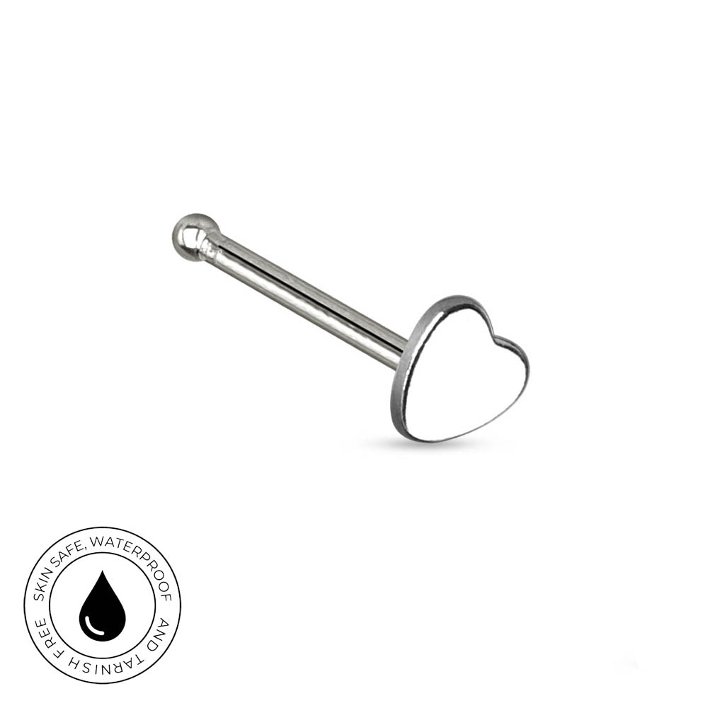 A silver-toned stainless steel labret piercing barbell with a polished heart-shaped end, shown on a white background with a circular 'Skin Safe Waterproof' badge in the bottom-left corner.