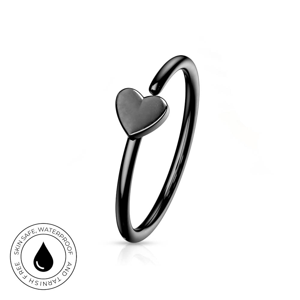A black titanium ear cuff ring with a small heart-shaped charm, shown on a white background with a circular 'Skin Safe Waterproof' badge in the bottom-left corner.