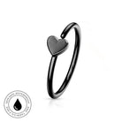 A black titanium ear cuff ring with a small heart-shaped charm, shown on a white background with a circular 'Skin Safe Waterproof' badge in the bottom-left corner.
