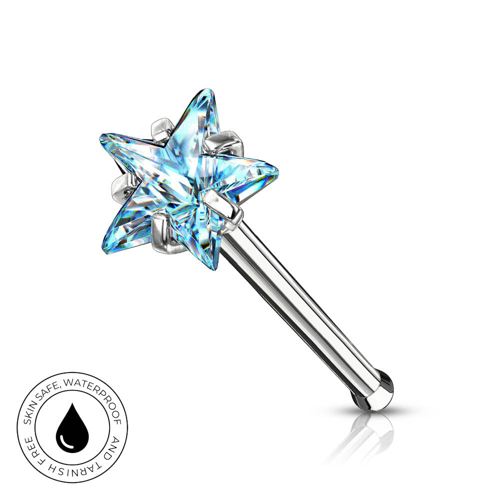 A silver-toned star-shaped nose ring with a faceted light blue crystal top, shown on a white background with a small circular 'Skin Safe Waterproof' badge in the lower left corner.