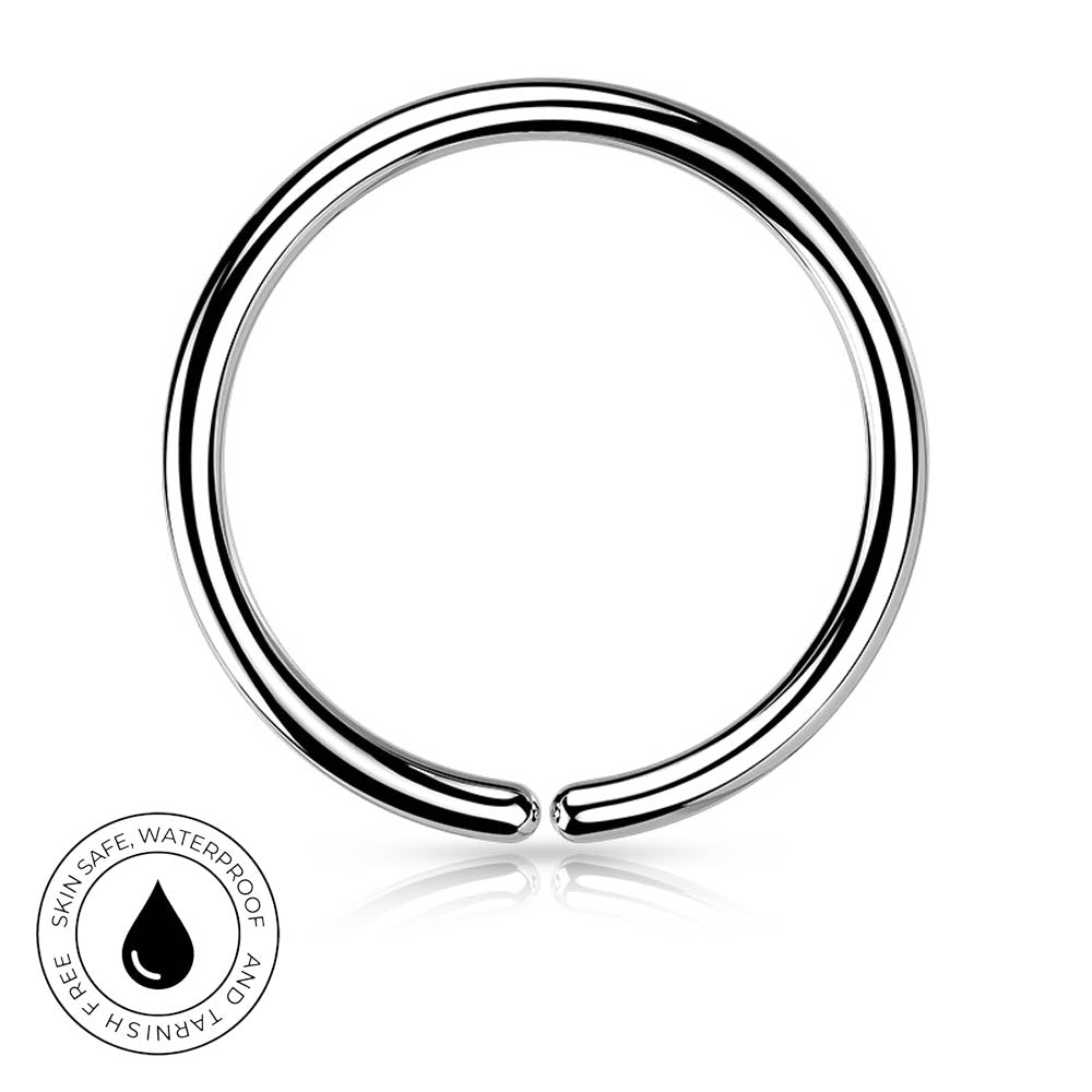 A polished silver-tone metal ring with a small gap, shown on a white background with a reflection below and a circular 'Skin Safe Waterproof' badge in the lower left corner.