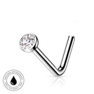 A silver-toned curved barbell piercing stud with a clear round gemstone, shown on a white background with a small circular 'skin-safe waterproof' badge in the lower left corner.