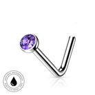 A silver-toned curved barbell nose ring with a round purple faceted gemstone, shown on a white background with a small 'skin-safe waterproof' badge in the lower left corner.