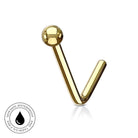 A gold-plated curved barbell labret piercing stud with a smooth spherical ball end, shown on a clean white background with a subtle reflection. A circular 'Skin Safe Waterproof' badge is visible in the bottom-left corner.