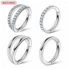 Four silver-toned huggie hoop earrings arranged in a 2x2 grid on a white background, with a pink 'MULTI PACK' label in the top-left corner. The earrings include various settings: double bands with clear stones on one earring, one with stones on the front half, one with no stones, and one fully plain.
