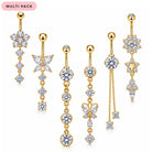 A set of six gold-plated navel jewelry piercings with clear rhinestones, featuring designs like flowers, butterflies, stars, and dangling chains, displayed on a white background with a pink 'MULTI PACK' label.