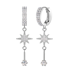 A pair of silver-toned dangle earrings adorned with clear pavé gemstones, featuring a huggie hoop, a vertical bar, a starburst motif, and a dangling round stone, set against a solid white background.