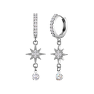 A pair of silver-toned dangle earrings with clear cubic zirconia stones, featuring a vertical bar with a pavé-set top, a starburst charm, and a dangling round stone, shown on a plain white background.