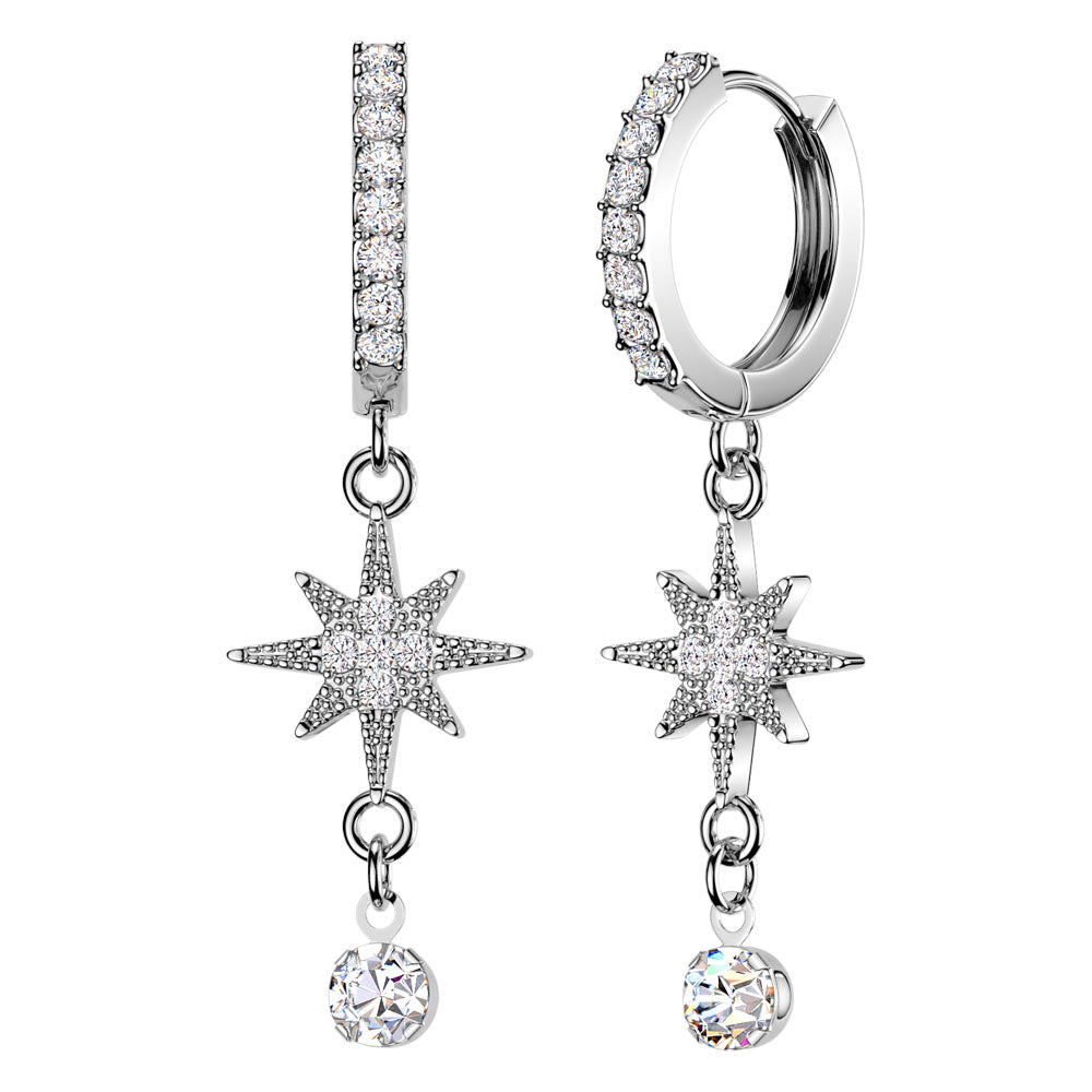 A pair of silver-toned dangle earrings with pavé-set clear stones, featuring a huggie hoop, a vertical bar, an eight-pointed star, and a dangling round crystal charm, shown on a plain white background.