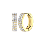 A pair of gold huggie hoop earrings paved with clear cubic zirconia stones, shown from two angles on a plain white background.