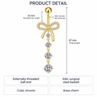 Product detail diagram of a gold-tone barbell piercing jewelry piece with a bow-shaped top, small clear stones, and a dangling cubic zirconia drop. The image includes dimension labels (10 mm wearable bar length, 47 mm total length) and feature callouts on a white background.