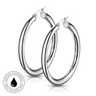 A pair of polished silver-tone hoop earrings with a double-ring design, shown on a clean white background with a subtle reflection. A circular badge in the bottom-left corner highlights 'SKINSAFE WATERPROOF' features.