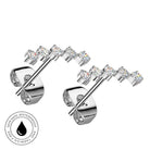 A pair of silver-toned stud earrings with five clear round-cut gemstones on each earring, shown on a white background with a circular 'Skin Safe Waterproof' badge in the lower left corner.
