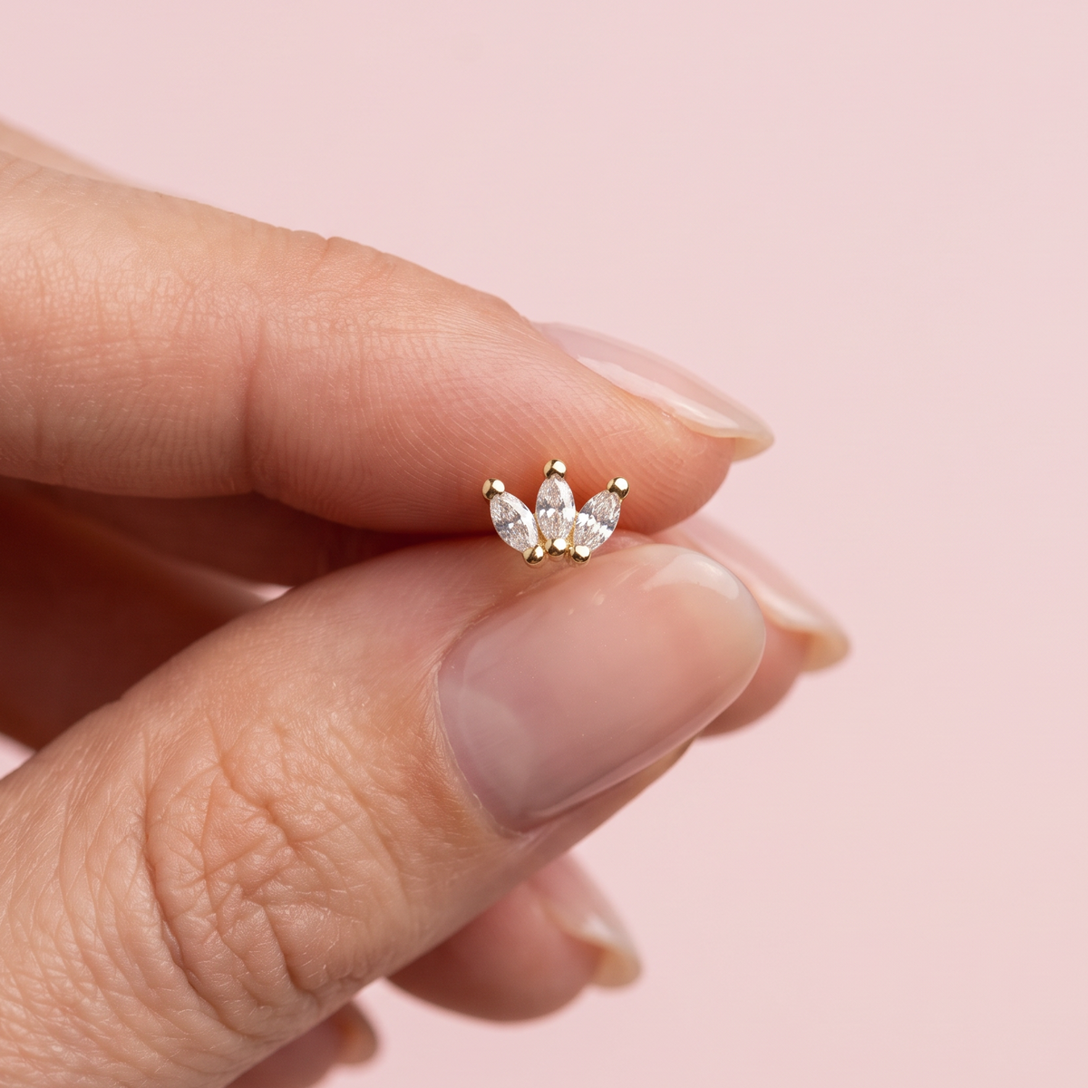 female model holding gold crystal marquise flower flat back stud
