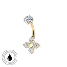 A curved barbell belly button ring in yellow gold, decorated with a round clear gemstone at the top and a four-petal flower cluster at the bottom. The image features a 'Skin Safe Waterproof' badge in the bottom-left corner on a solid white background.