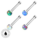 Four silver-toned labret piercing studs with round iridescent opal-like faceted tops, arranged on a white background with a circular 'Skin Safe Waterproof' badge in the lower left.