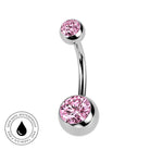 A curved barbell belly button ring with a polished silver-tone metal finish and two pink gemstone bezel settings, shown on a white background with a small circular 'Skin Safe Waterproof' badge in the lower left.