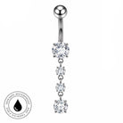 A silver-toned vertical belly button ring with a single round ball at the top, a large clear faceted stone in the center, three smaller clear stones below, and a circular 'Skin Safe Waterproof and Tarnish Free' badge on the bottom left.
