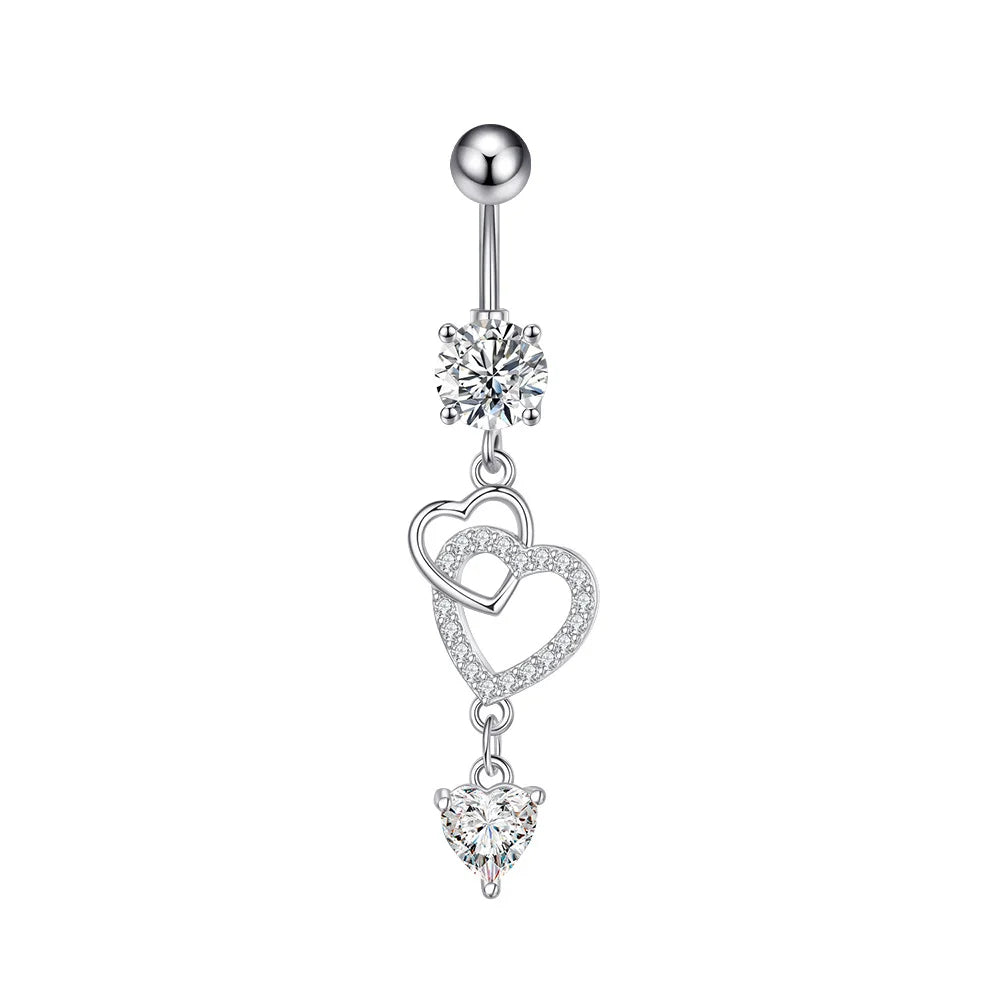A silver-toned belly button ring featuring a ball top, a round clear gemstone, and three dangling heart charms adorned with small clear stones, shown on a plain white background.
