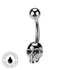 A silver-toned curved barbell belly button ring with a skull-shaped end and a smooth ball end, shown on a white background with a circular 'Skin Safe Waterproof' badge in the lower left corner.