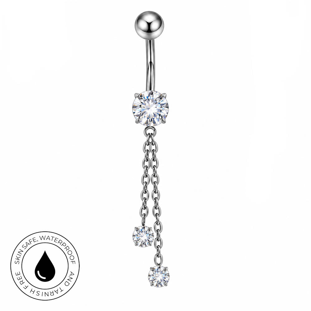 Silver-toned navel barbell piercing with a large clear crystal flower at the belly button, two dangling chain links, and three smaller clear crystal flowers, shown on a white background with a circular 'skin-safe waterproof' badge in the lower left.