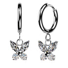 A pair of silver huggie hoop earrings, each adorned with a dangling butterfly charm made of clear marquise and round gemstones, shown against a plain white background.